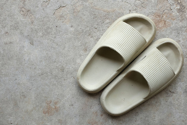 top view and flat lay a pair of slides with an open toe pillow isolated on a on cement floor background. Women's fashion. Women's summer footwear.  - Φωτογραφία, εικόνα