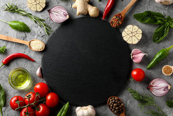 Different ingredients for cooking on gray textured background - 写真・画像
