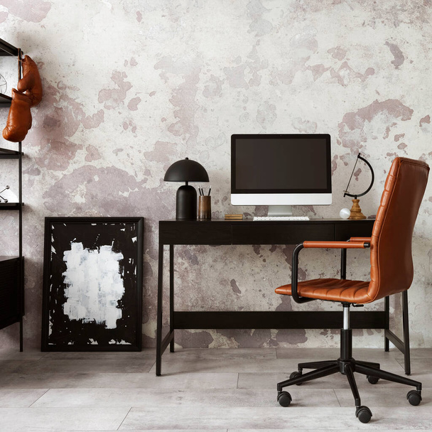 Concrete interior of home office with black desk, brown armchair, computer screen, office accessories and lamp. Rack with personal accessories. Home decor. Template.  - Fotoğraf, Görsel