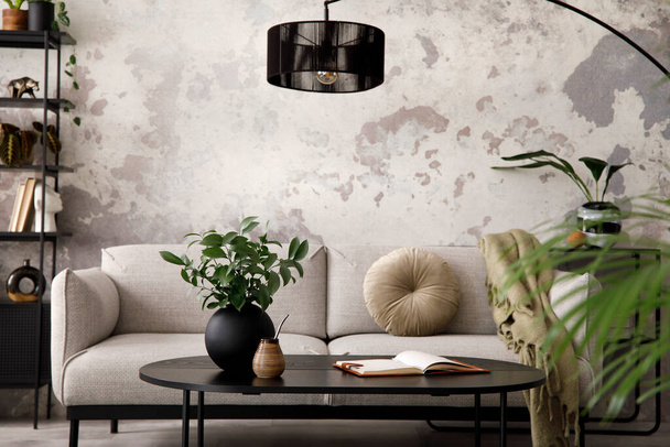 The stylish compostion at living room interior with design gray sofa, black coffee table, lamp and elegant personal accessories. Loft and industrial interior. Template. - Φωτογραφία, εικόνα