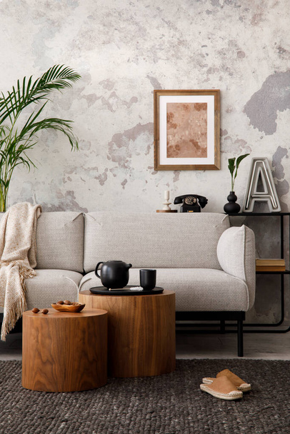 The stylish compostion at living room interior with design gray sofa, woooden coffee table, poster and elegant personal accessories. Loft and industrial interior. Template.  - Φωτογραφία, εικόνα