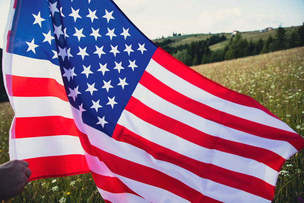Close up view of USA flag against a summer meadow. 4th of July - Independence day. - Valokuva, kuva