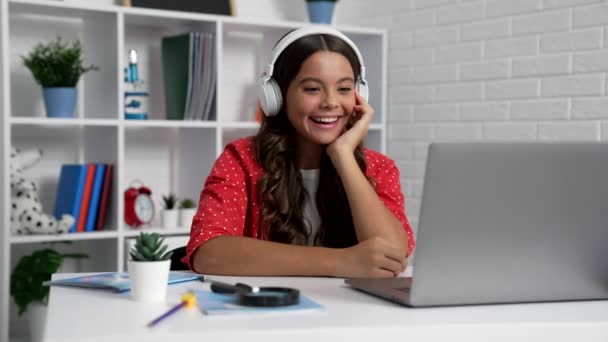 happy teen girl laughing while something funny in headphones at laptop, happiness. - Video