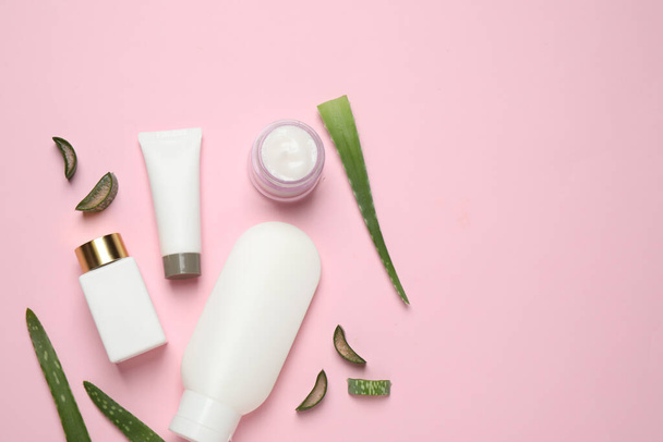 Flat lay composition with aloe vera and cosmetic products on pink background. Space for text - Fotó, kép