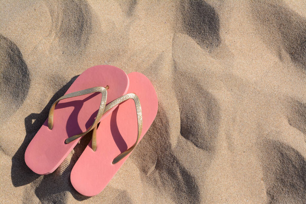 Stylish flip flops on sandy beach, flat lay. Space for text - Valokuva, kuva