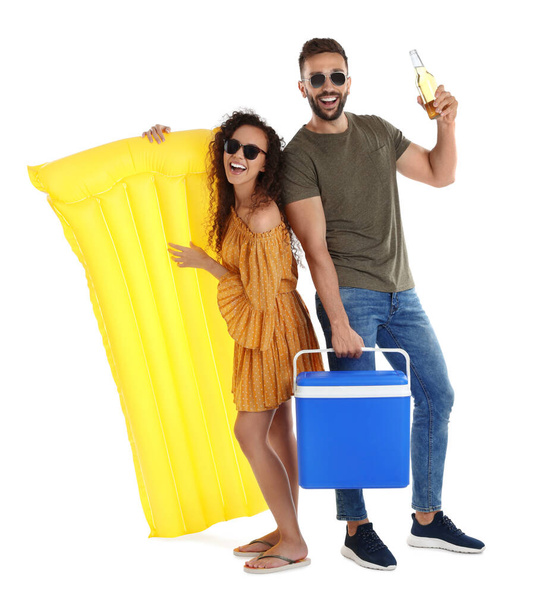 Happy couple with cool box, inflatable mattress and bottle of beer on white background - Foto, immagini