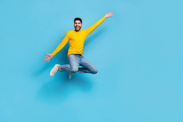 Full size photo of overjoyed crazy person jumping have fun good mood empty space isolated on blue color background. - Valokuva, kuva