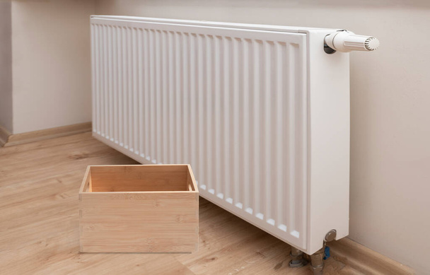 empty wooden box and Modern white radiator with thermostat background - Zdjęcie, obraz