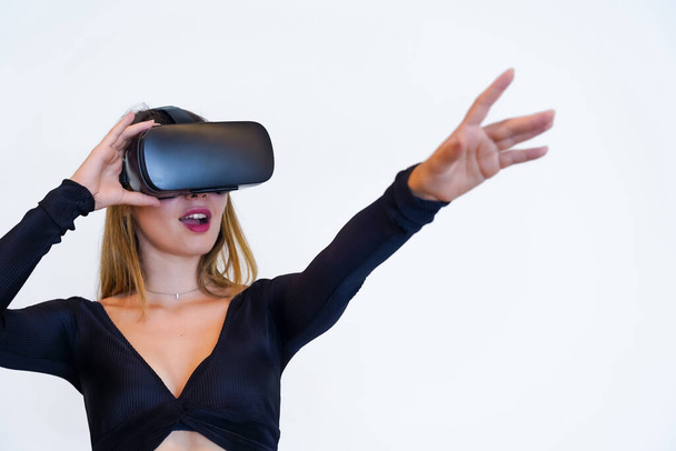 Woman with virtual reality glasses on white background, futuristic concept, metaverse, parallel virtual life - Zdjęcie, obraz