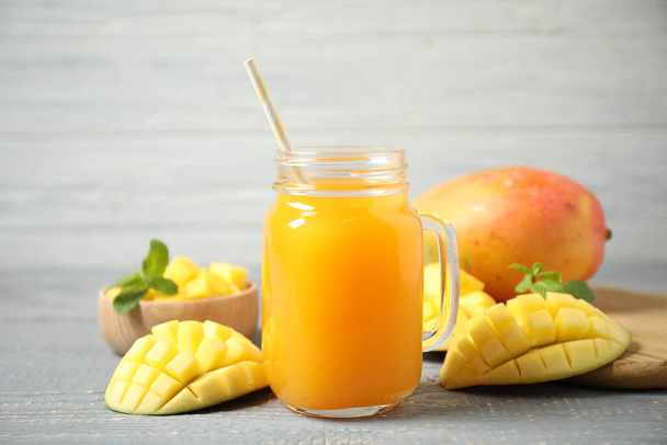 Fresh delicious mango drink on wooden table - Φωτογραφία, εικόνα