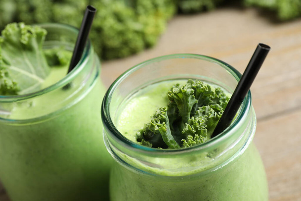Tasty fresh kale smoothie on table, closeup - Foto, Imagen