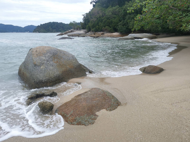 daytime scene of boulders along the beach. - Foto, imagen