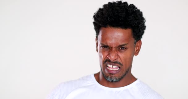 African man disgust face reaction. Black guy feeling dislike - Πλάνα, βίντεο