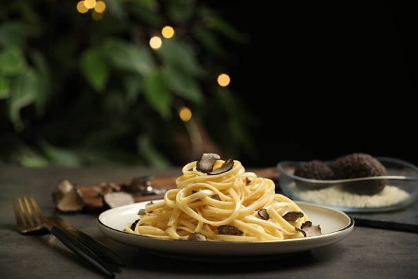 Tasty fettuccine with truffle on grey table - Photo, image