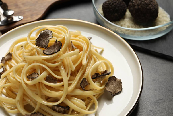 Tasty fettuccine with truffle on grey table, closeup - Photo, image