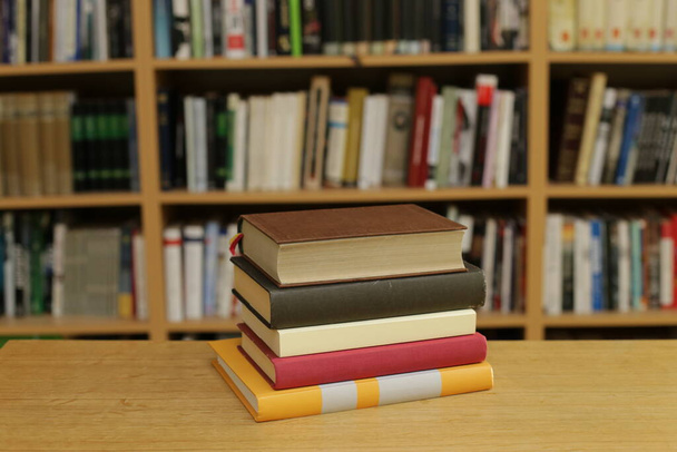 books and bookshelves on a wooden shelf. - 写真・画像