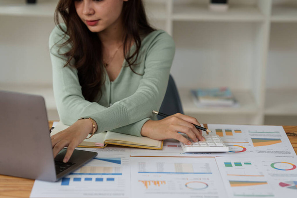Business Woman analyzes companys financial system and paperwork on desk. - Zdjęcie, obraz