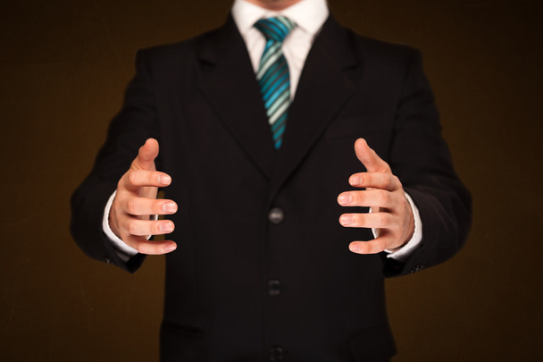 Businessman holding something - Фото, изображение