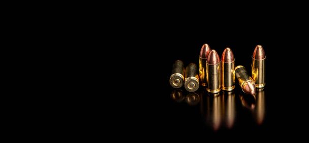 Pistol cartridges 9 mm on a smooth glossy surface with reflections. Ammunition for pistols and PCC carbines on a dark background. - Fotoğraf, Görsel