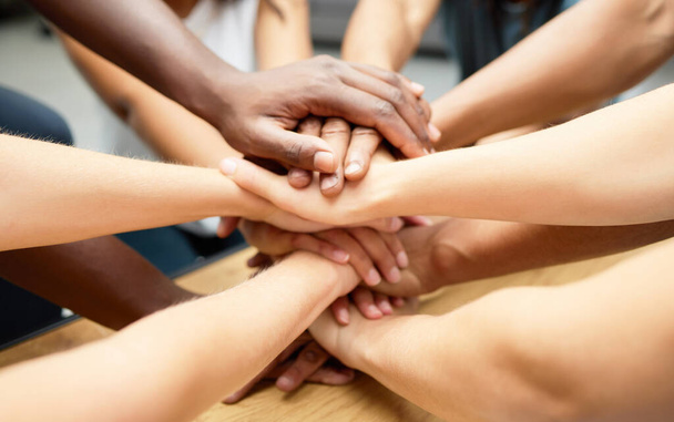 Were stronger as a team. a diverse team of staff piling their hands together - Фото, зображення