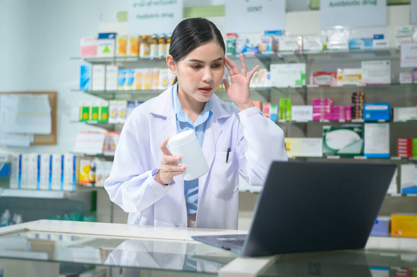 A Female pharmacist counseling customer via video call in a modern pharmacy drugstore. - Foto, Imagen
