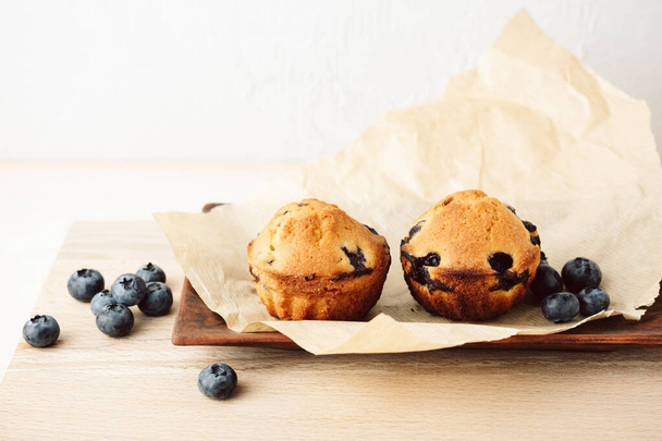 Two mini cakes with blueberries on a tray. - Valokuva, kuva