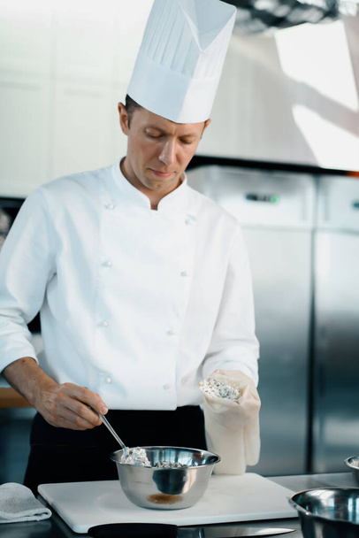 Professional kitchen of a restaurant, close-up: a male chef prepares a filling for french omelet - Zdjęcie, obraz