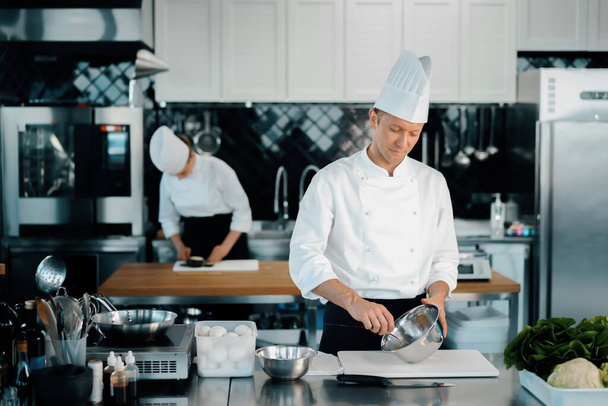 Professional restaurant kitchen: chefs prepare delicious dish - Valokuva, kuva