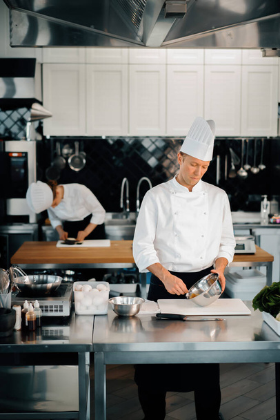 Professional restaurant kitchen: chefs prepare delicious dish - Fotoğraf, Görsel