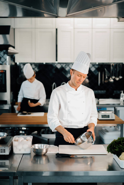 Professional restaurant kitchen: chefs prepare delicious dish - Foto, immagini