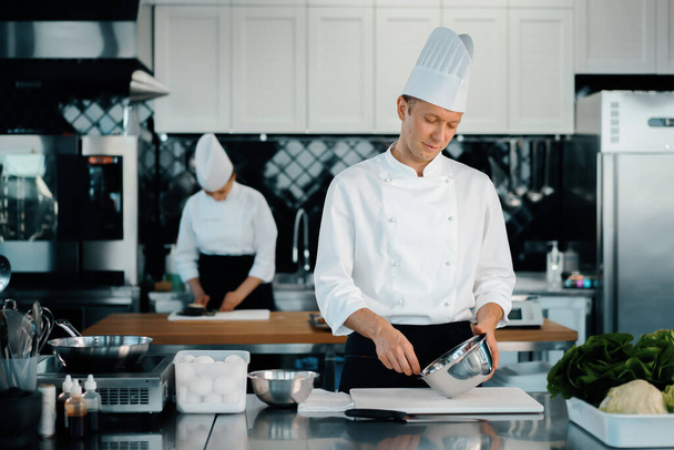 Professional restaurant kitchen: chefs prepare delicious dish - Zdjęcie, obraz