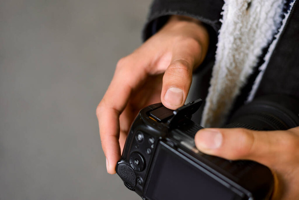 Close up shot of hands of a man putting a battery into the camera. Copy space, professional shooting, photographer. - 写真・画像