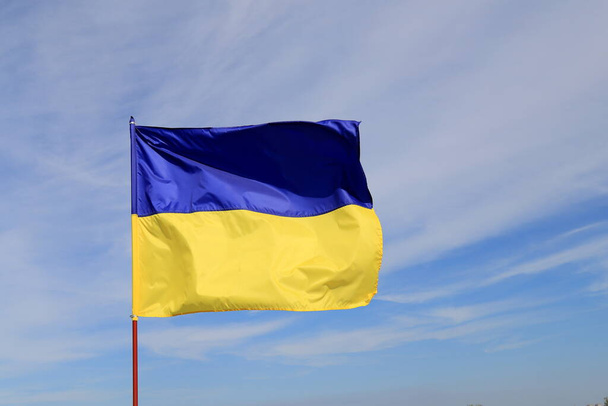 Ukraine flag, national symbol fluttering in cloudy blue sky. Yellow blue Ukrainian state flag, Dnipro city, Independence Constitution Day - Фото, зображення