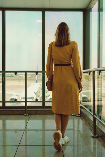 Woman waiting for her flight in the airport. - Photo, image
