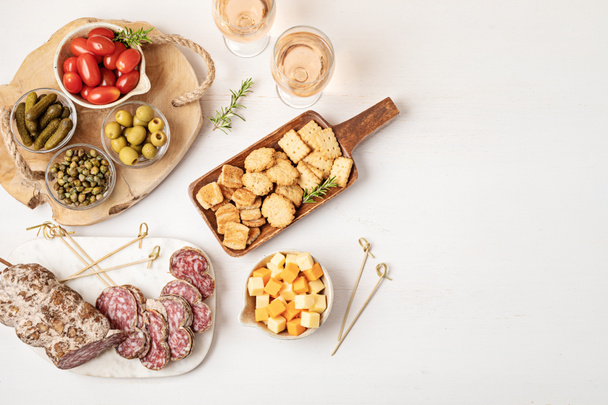 Appetizers table with different antipasti, charcuterie, snacks, cheese. Finger food for buffet party. Traditional french or italian entires. Top view - Фото, изображение