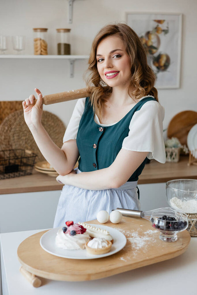 Pretty girl cooking in the kitchen. High quality photo - Zdjęcie, obraz