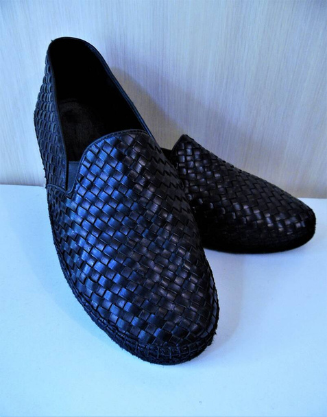 men's shoes loafers made of interlaced black leather on a white background - Foto, immagini