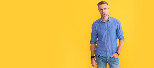 mature man with wrist watch on yellow background, fashion accessory. Man face portrait, banner with copy space - Valokuva, kuva