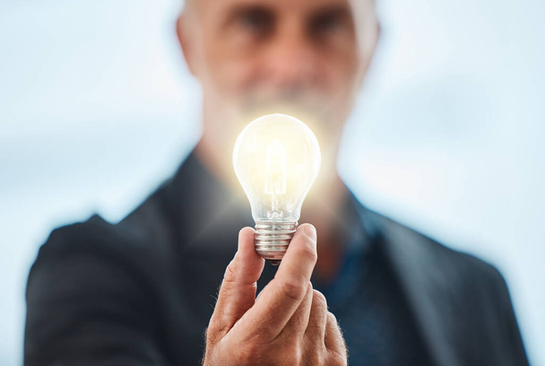 First dream it, then achieve it. an unrecognisable businessman holding a lightbulb - Photo, image