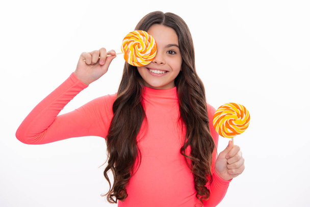Teenager girl with caramel candies on sticks, sweet sugar addiction. Child with lollipops. Happy girl face, positive and smiling emotions - Fotografie, Obrázek