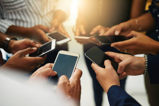 Business people hands typing on a phone, closeup texting on social media or reading emails or online news. Diverse group of colleagues social networking, looking at copyspace mobile screens - Foto, Imagem