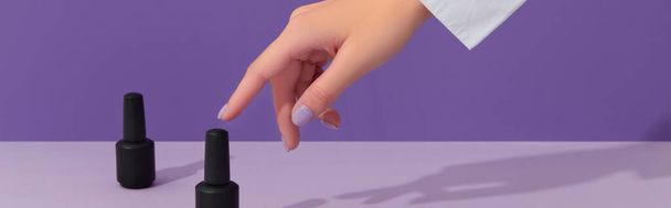 Womans hand with trendy pastel color nails over purple background. Spring summer nail design. Manicure, pedicure beauty salon concept. - Foto, Bild