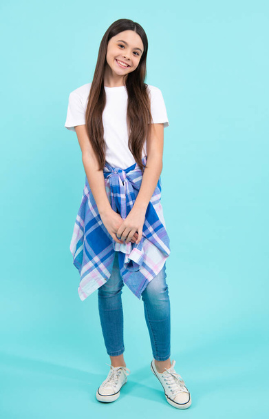 Elegant fashion teenager child girl posing in studio. Trends kids clothes. Happy teenager, positive and smiling emotions of teen girl - Foto, Imagen