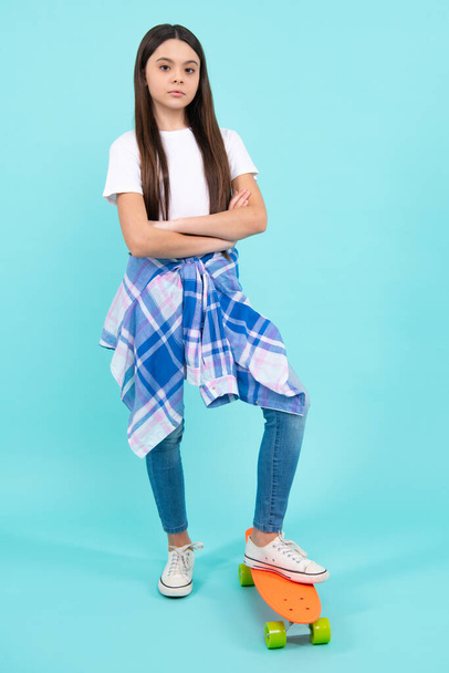 Fashion teenage lifestyle, beautiful teen girl with skateboard isolated on studio background - Zdjęcie, obraz