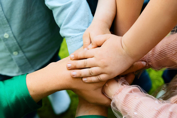 children's hands on each other, team sign - Фото, изображение