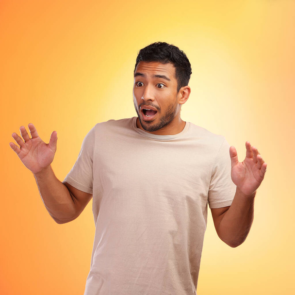 What just happened. a young man looking surprised while standing against a yellow background - Photo, Image
