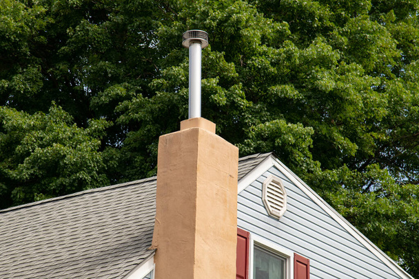 chimney from the fireplace outside house building roof top - Foto, Bild