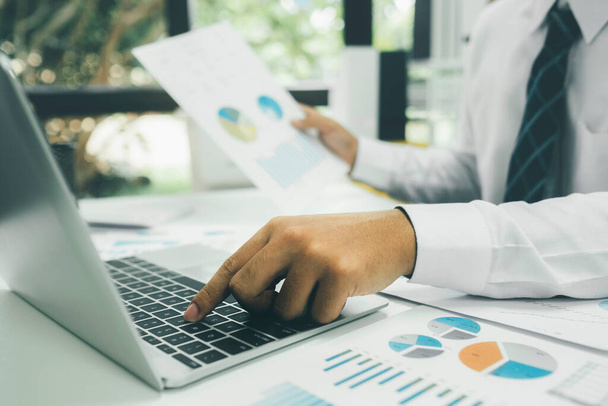 Businessman planning and analyse investment marketing data on laptop. - Fotó, kép