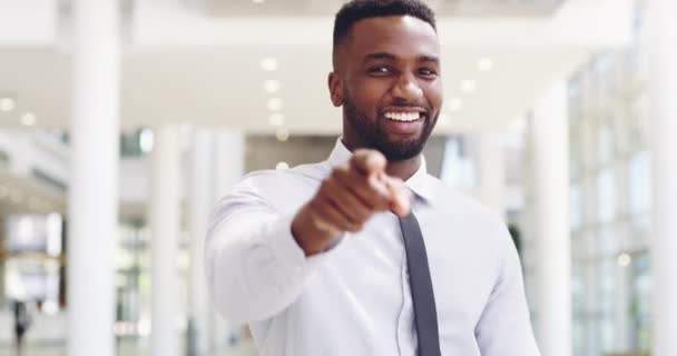 Happy young businessman pointing at you in a modern office. Smiling business man employer looking and selecting person for new job. Excited male at office choosing employee and clapping hands - Materiaali, video