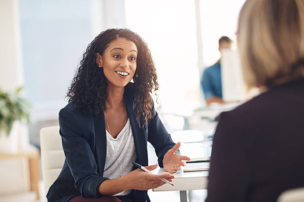 Interview with a happy, excited and confident human resources manager talking to a shortlist candidate for a job. Young business woman meeting with a colleague or coworker in her office at work. - Fotoğraf, Görsel